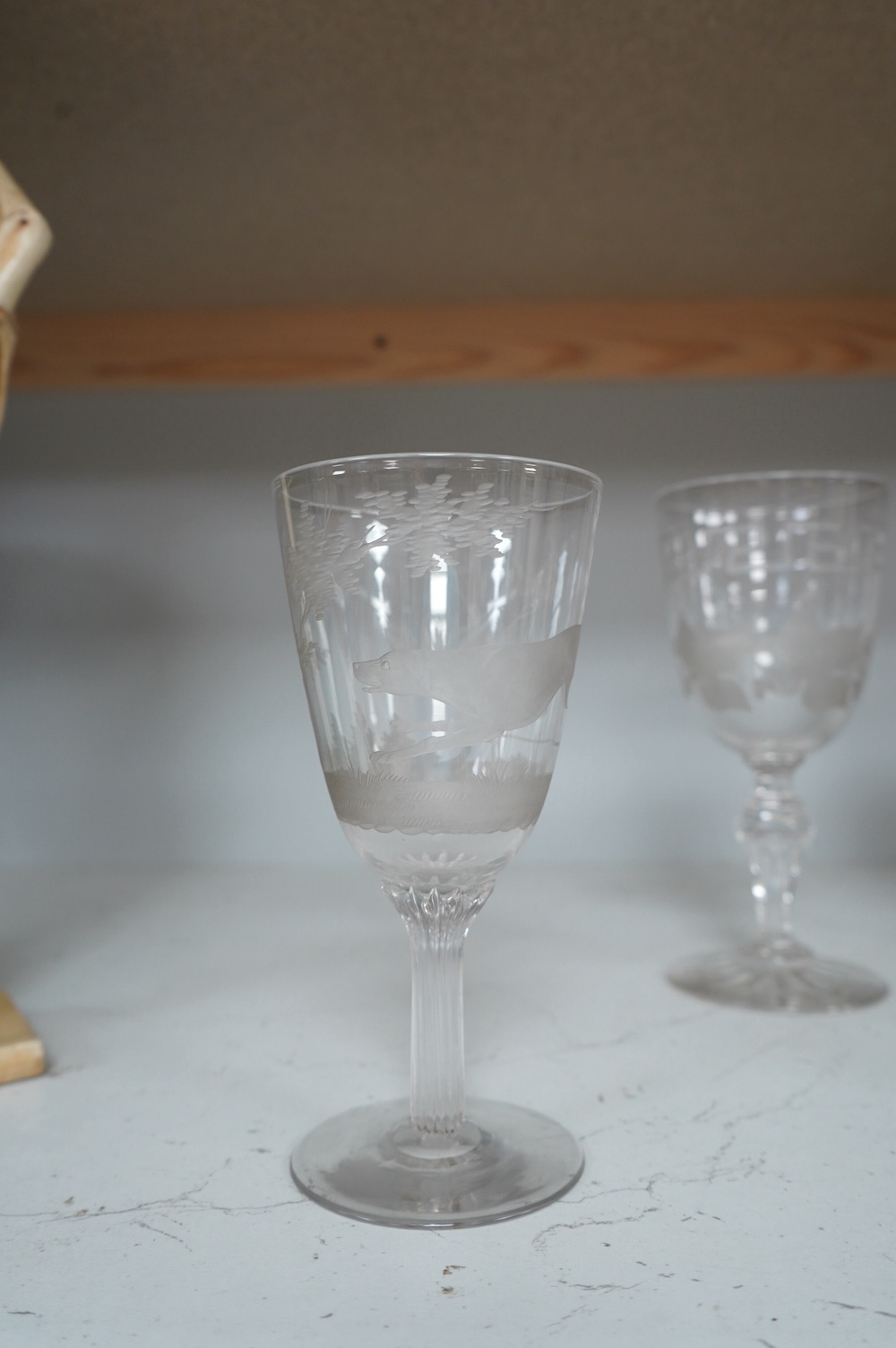 A Victorian Stourbridge wine glass, the bowl engraved with a running rabbit, together with six other glasses, tallest 19cm (7). Condition - good